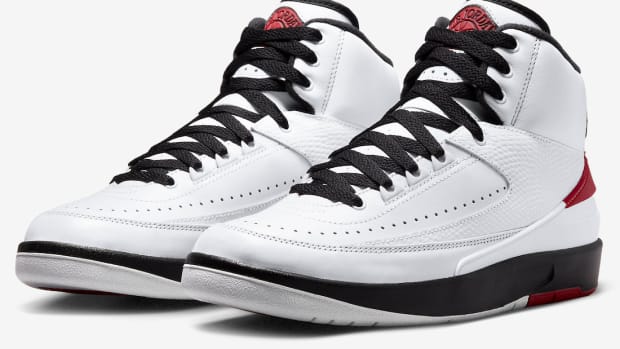View of white, black, and red Jordan shoes.